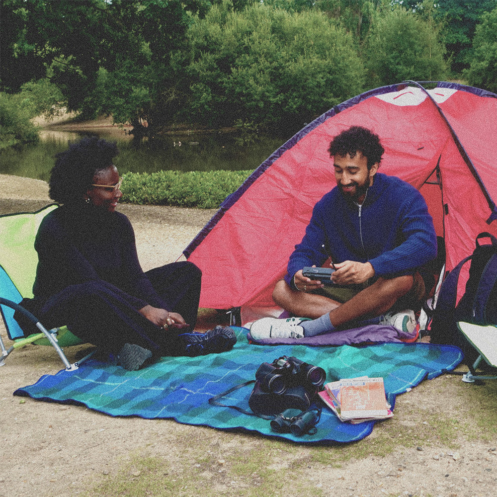 two people sat in front of a tent